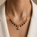 Gold-Plated Black Heart Charm Necklace with Teardrop Crystal Pendant